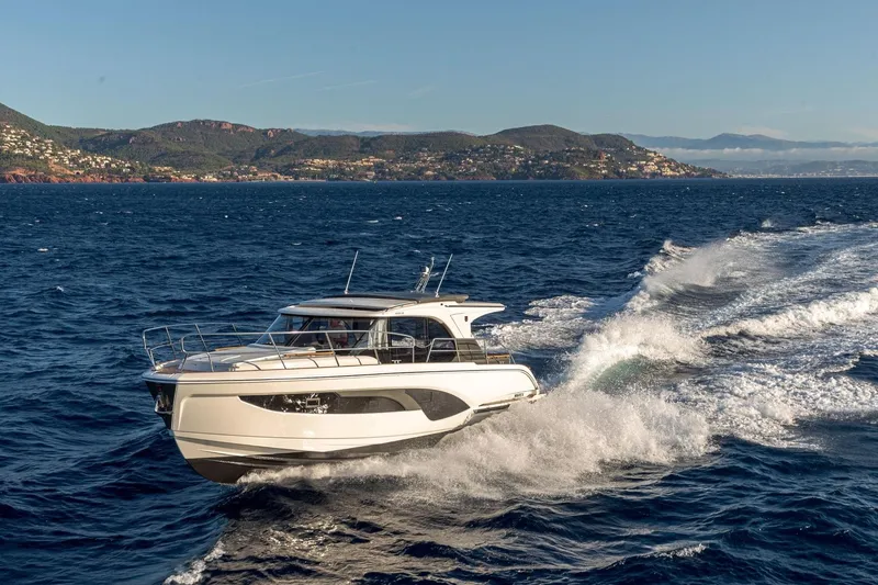  Yacht Photos Pics 2026 Marex 390 yacht cruising on open sea with scenic coastal backdrop.