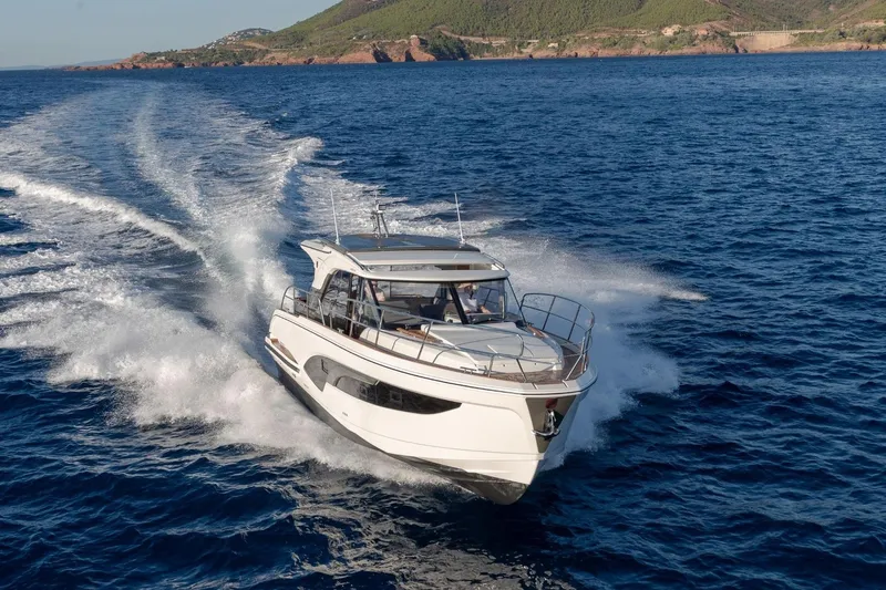  Yacht Photos Pics 2026 Marex 390 yacht cruising on open sea with scenic coastal backdrop.