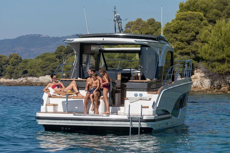  Yacht Photos Pics 2026 Marex 390 yacht with people relaxing on deck in scenic coastal waters.