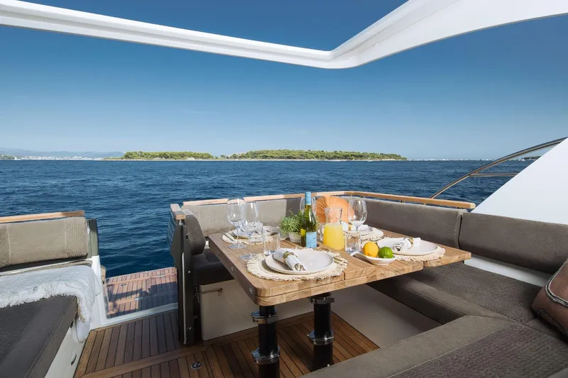  Yacht Photos Pics Luxury dining setup on 2026 Marex 390 yacht with ocean view.