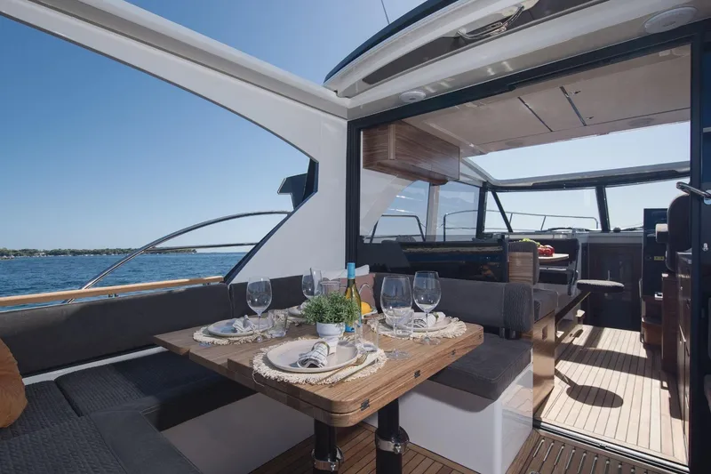  Yacht Photos Pics Luxurious Marex 390 yacht interior, 2026 model, featuring elegant dining setup and scenic ocean view.
