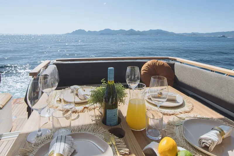  Yacht Photos Pics Luxurious dining setup on Marex 390 yacht, 2026, with ocean view and elegant tableware.