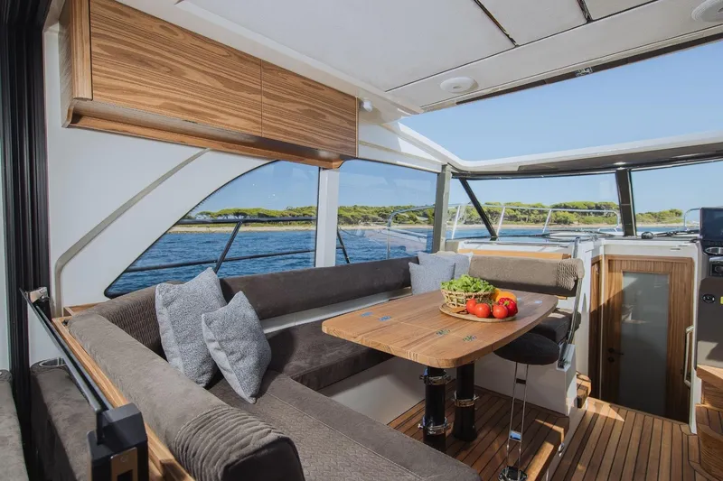  Yacht Photos Pics Luxurious Marex 390 yacht interior with elegant seating and dining area, featuring scenic ocean views.