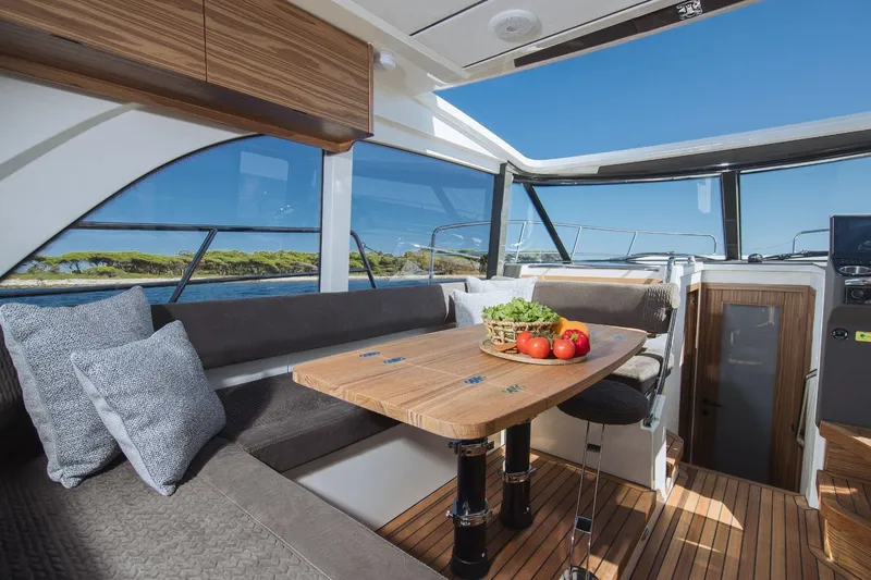  Yacht Photos Pics Luxurious interior of 2026 Marex 390 yacht with dining area and scenic views.