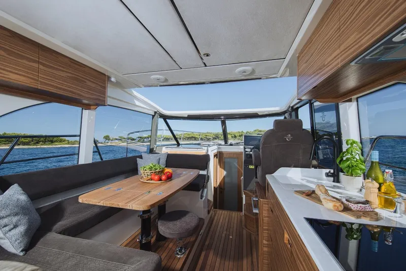  Yacht Photos Pics Luxurious interior of 2026 Marex 390 yacht with modern kitchen and dining area.