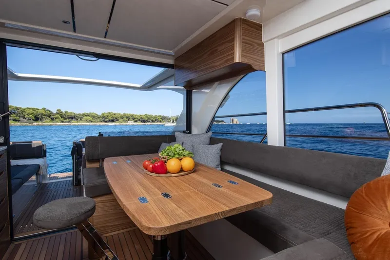  Yacht Photos Pics Interior of 2026 Marex 390 yacht with dining table and sea view.