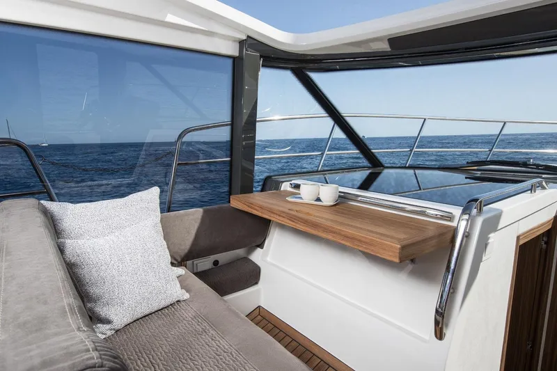  Yacht Photos Pics Interior of 2026 Marex 390 yacht with ocean view, featuring a cozy seating area.