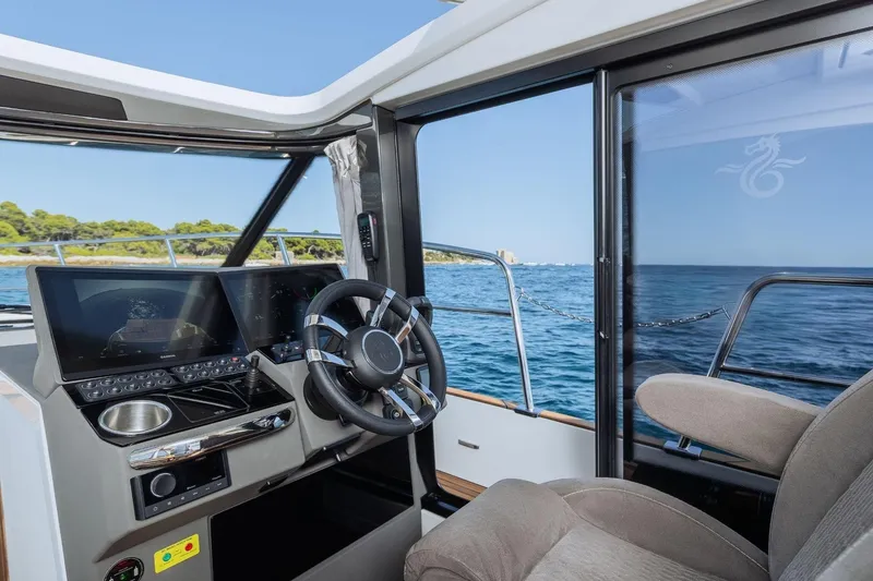  Yacht Photos Pics Interior view of 2026 Marex 390 boat cockpit with ocean scenery.