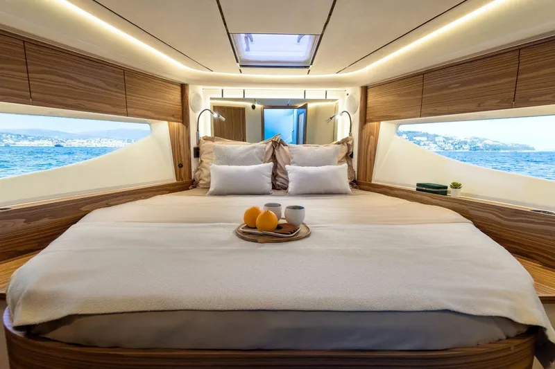  Yacht Photos Pics Luxurious Marex 390 yacht bedroom interior with ocean view, featuring elegant wood finishes, 2026 model.