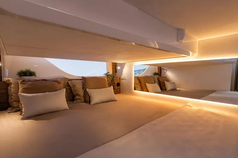  Yacht Photos Pics Luxurious interior cabin of 2026 Marex 390 yacht with cozy bedding and ambient lighting.