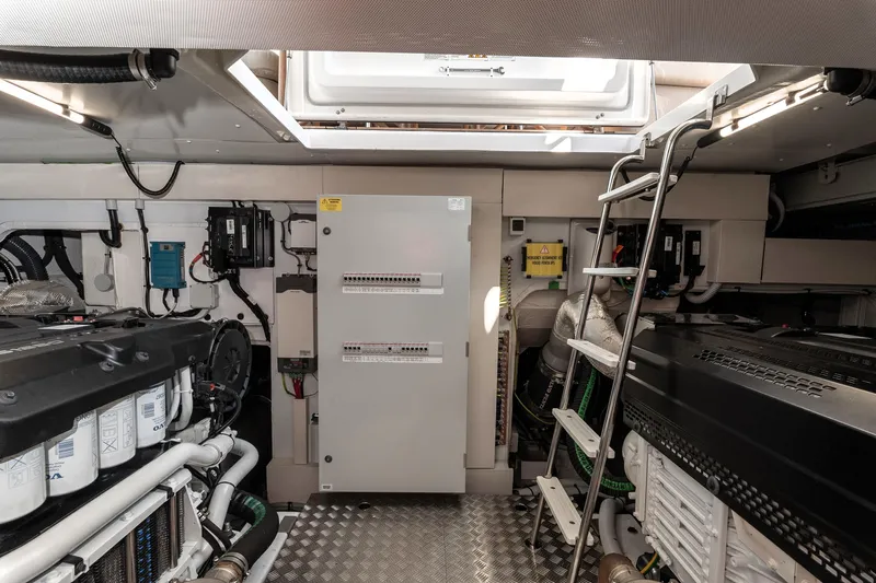  Yacht Photos Pics Engine room of 2024 Azimut 68 yacht, featuring modern equipment and ladder access.