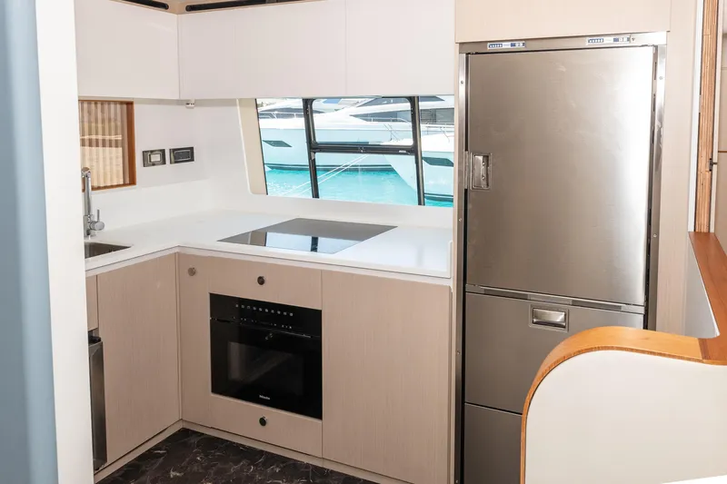  Yacht Photos Pics Modern kitchen interior on 2024 Azimut 68 yacht, featuring sleek appliances and waterfront view.