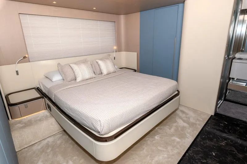  Yacht Photos Pics Luxurious bedroom interior of 2024 Azimut 68 yacht with modern design and elegant furnishings.