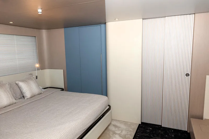  Yacht Photos Pics Luxurious bedroom interior of 2024 Azimut 68 yacht, featuring modern design and comfortable bedding.