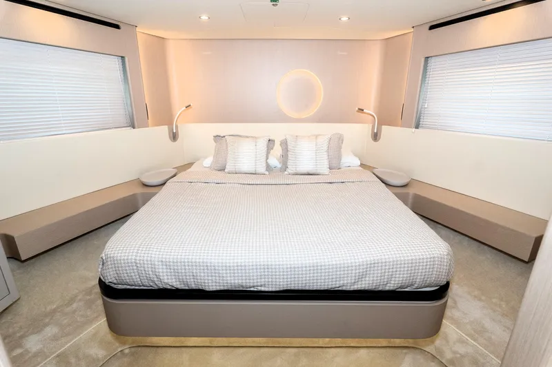  Yacht Photos Pics Luxurious bedroom interior of 2024 Azimut 68 yacht with modern design and elegant bedding.