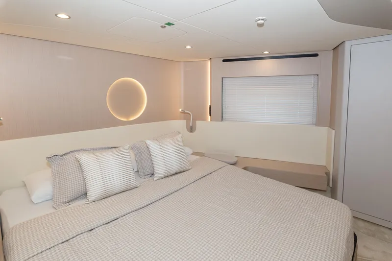  Yacht Photos Pics Luxurious bedroom interior of 2024 Azimut 68 yacht with modern design and ambient lighting.
