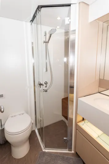  Yacht Photos Pics Modern bathroom in 2024 Azimut 68 yacht with glass shower and sleek fixtures.