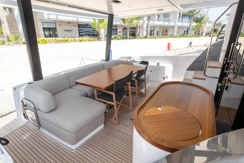  Yacht Photos Pics 2024 Azimut 68 yacht deck with seating, table, and bar area.