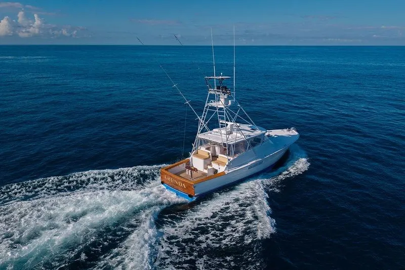 Chunda Yacht Photos Pics 1998 Merritt 48 yacht cruising on open ocean under clear blue sky.
