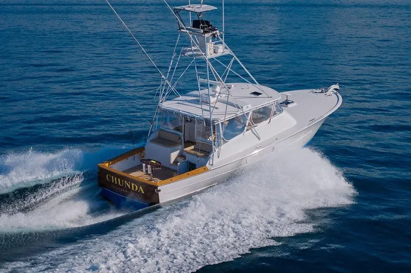 Chunda Yacht Photos Pics 1998 Merritt 48 yacht cruising on open water, showcasing sleek design and powerful performance.