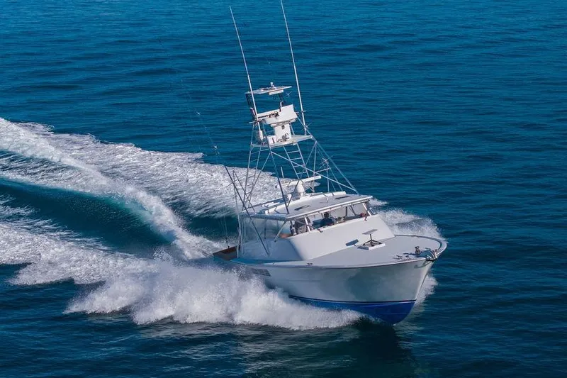 Chunda Yacht Photos Pics 1998 Merritt 48 yacht cruising swiftly on open blue ocean waters.