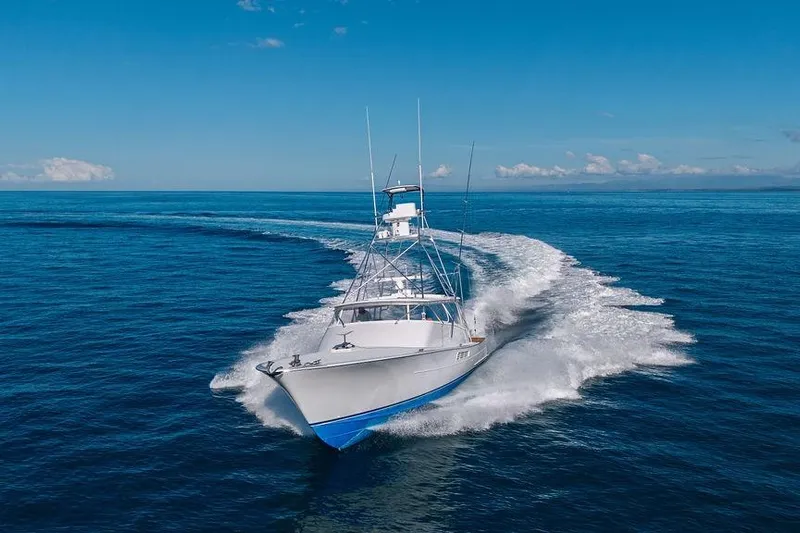 Chunda Yacht Photos Pics 1998 Merritt 48 yacht cruising on open blue ocean under clear sky.