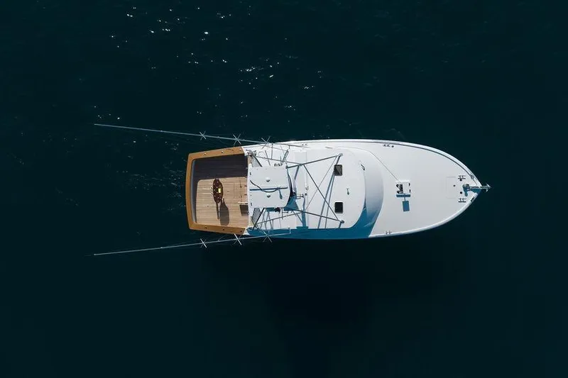 Chunda Yacht Photos Pics Aerial view of 1998 Merritt 48 yacht on calm dark water.