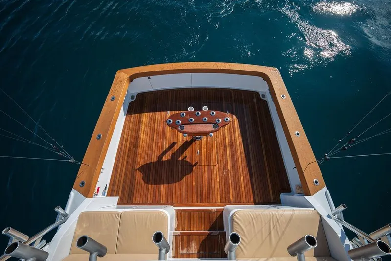 Chunda Yacht Photos Pics Aerial view of 1998 Merritt 48 yacht deck with wooden finish and fishing rod holders.