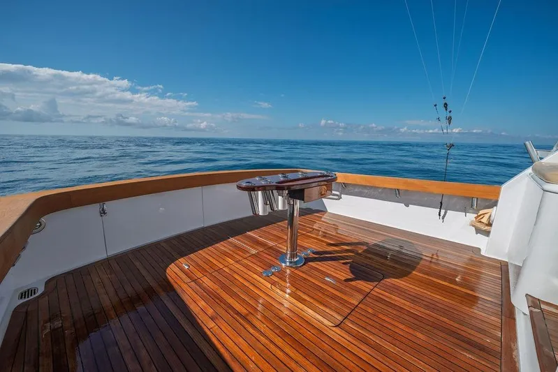 Chunda Yacht Photos Pics Sleek Merritt 48 yacht deck with polished wood, ocean view, and clear blue sky.