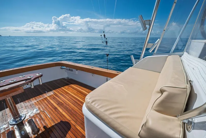 Chunda Yacht Photos Pics Luxury Merritt 48 yacht deck with cushioned seating, overlooking serene ocean view.