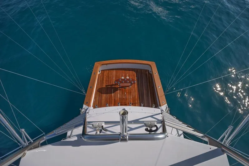 Chunda Yacht Photos Pics Aerial view of 1998 Merritt 48 yacht deck on clear blue water.