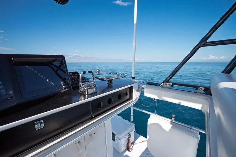 Chunda Yacht Photos Pics Helm of 1998 Merritt 48 yacht with ocean view and navigation equipment.