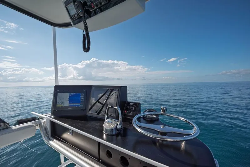 Chunda Yacht Photos Pics Helm of 1998 Merritt 48 yacht with navigation equipment, overlooking calm ocean.