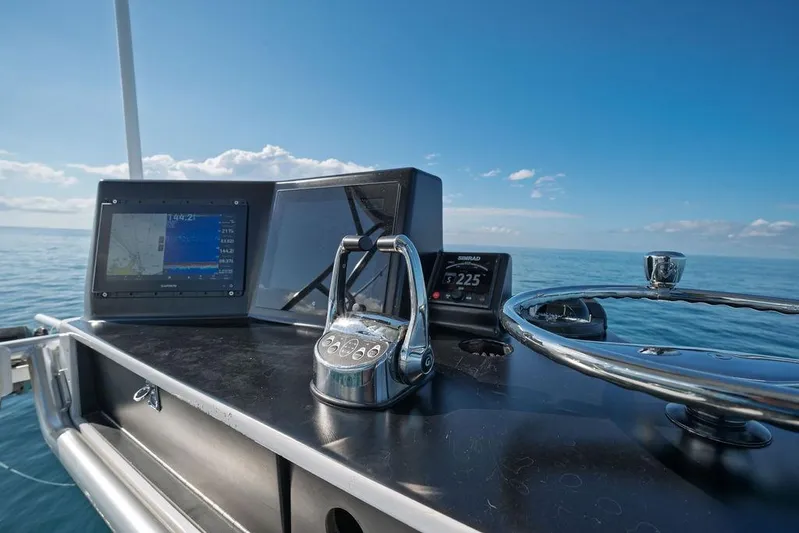 Chunda Yacht Photos Pics Control panel of a 1998 Merritt 48 yacht with navigation equipment, overlooking the ocean.