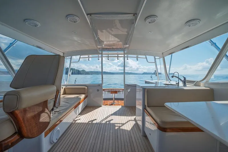 Chunda Yacht Photos Pics Interior of 1998 Merritt 48 yacht with ocean view, featuring seating and a sink.