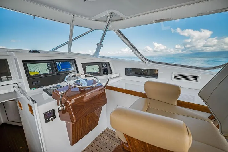 Chunda Yacht Photos Pics Helm of 1998 Merritt 48 yacht with navigation screens and ocean view.