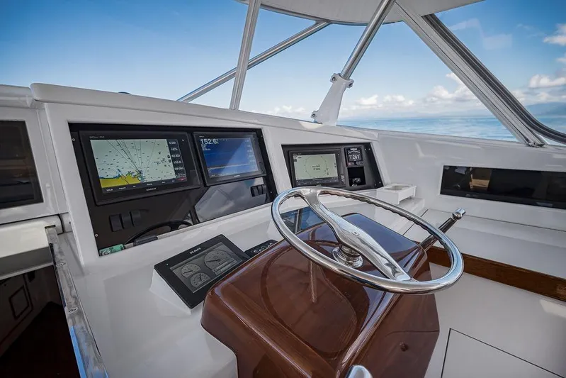 Chunda Yacht Photos Pics Cockpit of 1998 Merritt 48 yacht with navigation screens and steering wheel.