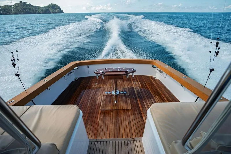 Chunda Yacht Photos Pics Sleek Merritt 48 yacht cruising on open sea, leaving a foamy wake behind.