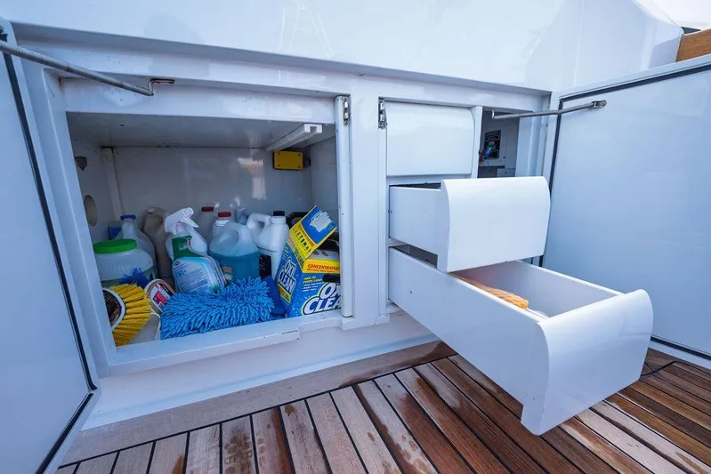 Chunda Yacht Photos Pics Storage compartment on 1998 Merritt 48 yacht with cleaning supplies and open drawers.