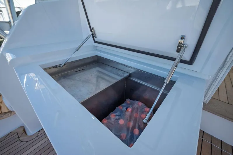 Chunda Yacht Photos Pics Open storage compartment on 1998 Merritt 48 boat, showcasing interior space and hydraulic supports.