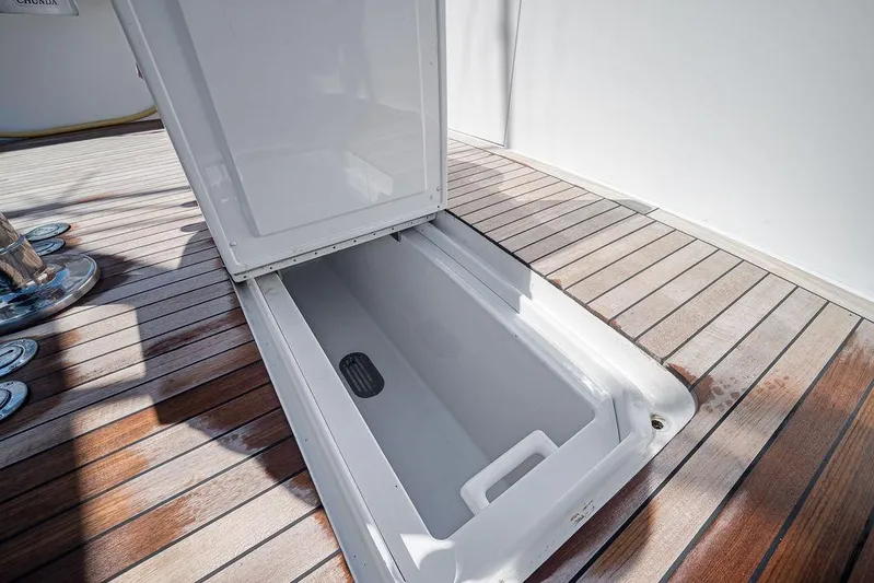 Chunda Yacht Photos Pics Open storage compartment on 1998 Merritt 48 yacht with wooden deck.
