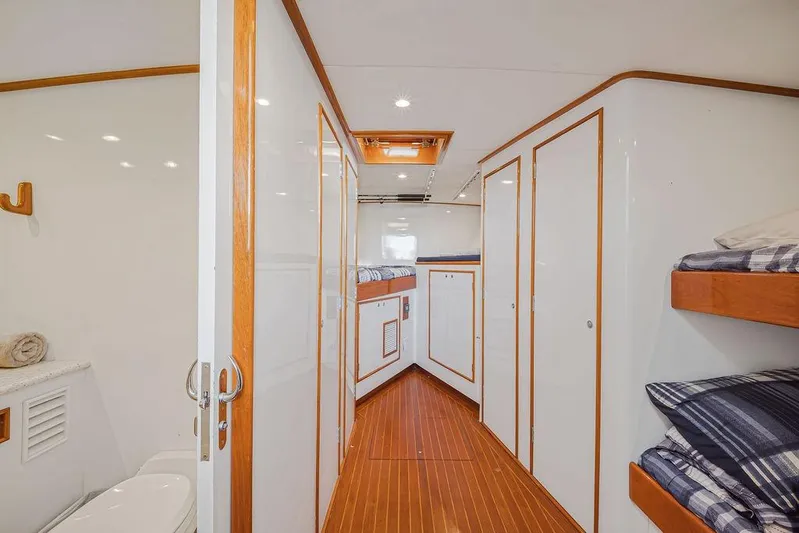 Chunda Yacht Photos Pics Luxurious Merritt 48 yacht interior, featuring wooden accents and cozy sleeping quarters, 1998 model.