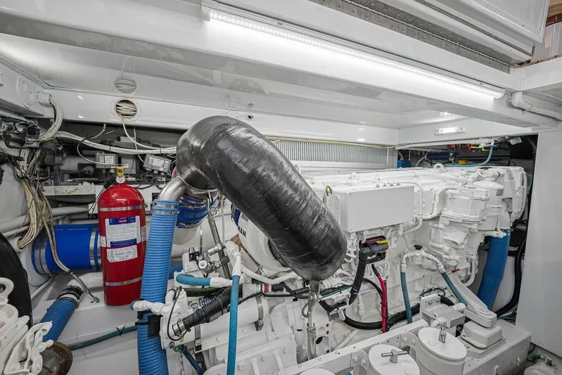 Chunda Yacht Photos Pics Engine room of a 1998 Merritt 48 yacht, featuring complex machinery and fire safety equipment.