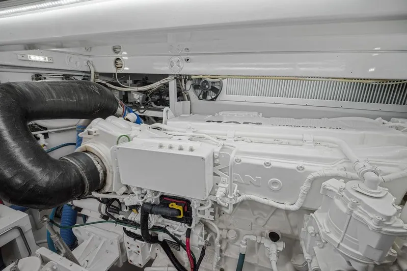 Chunda Yacht Photos Pics Engine room of a 1998 Merritt 48 yacht, featuring a clean, white engine setup.