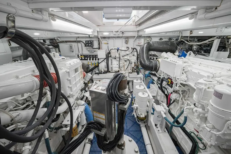 Chunda Yacht Photos Pics Engine room of a 1998 Merritt 48 yacht, showcasing complex machinery and cables.