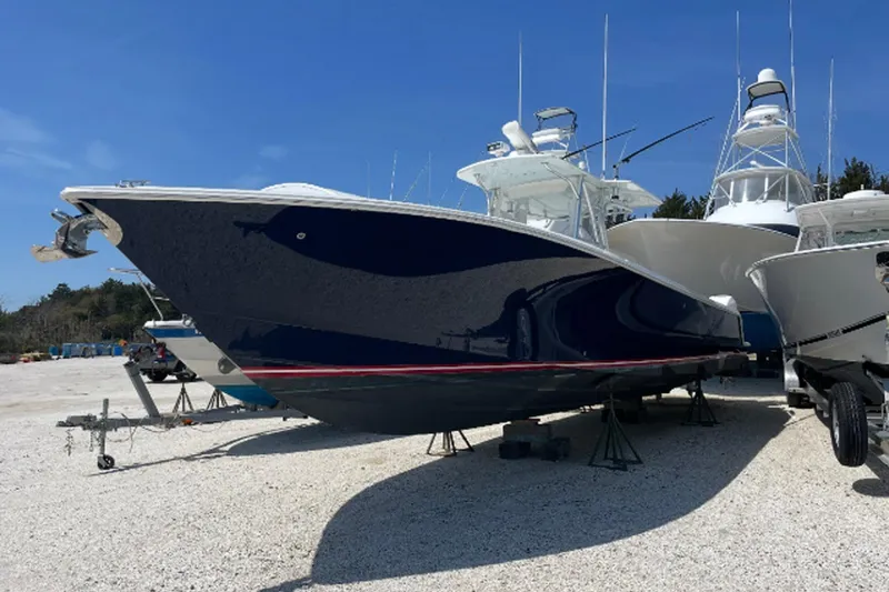Showtime Yacht Photos Pics 2015 SeaVee 390Z boat on dry dock, blue hull, clear sky background.