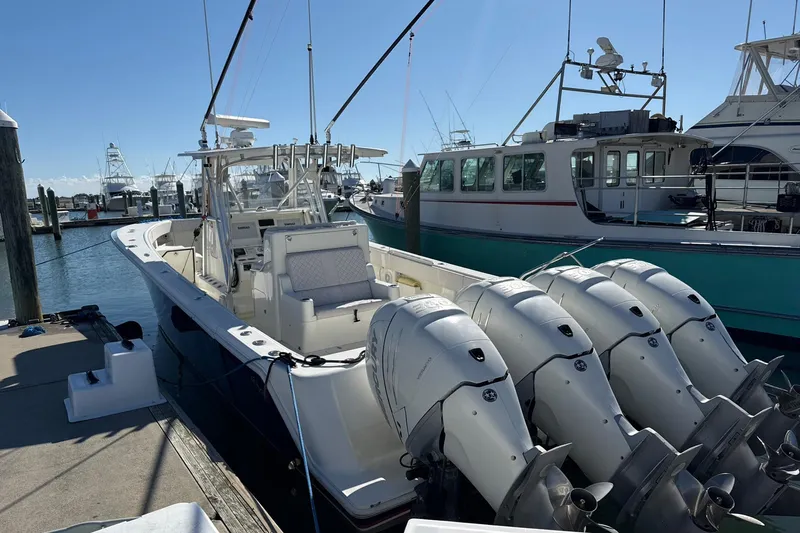 Showtime Yacht Photos Pics 2015 SeaVee 390Z boat docked, featuring four powerful outboard engines.