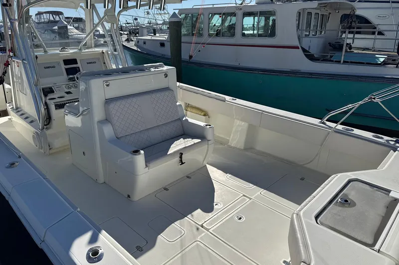 Showtime Yacht Photos Pics 2015 SeaVee 390Z boat interior with seating and control panel, docked at marina.