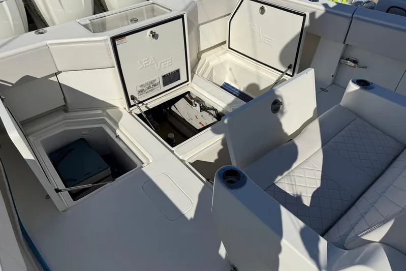 Showtime Yacht Photos Pics 2015 SeaVee 390Z boat interior with open storage compartments and cushioned seating.