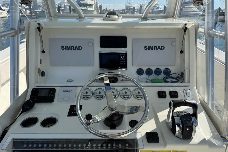 Showtime Yacht Photos Pics 2015 SeaVee 390Z boat dashboard with Simrad navigation system and controls.